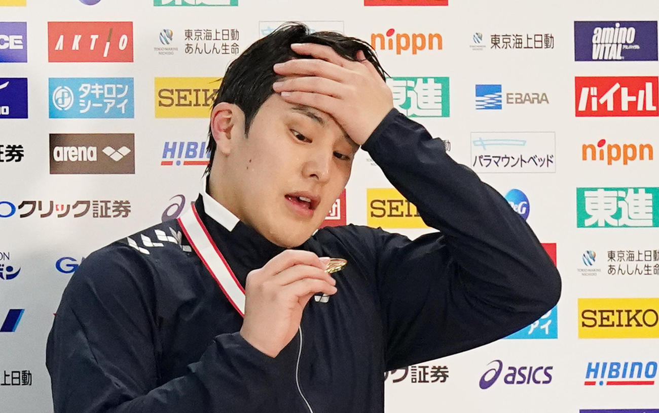 復帰戦のジャパンオープン男子400メートル個人メドレーで優勝し、手にしたメダルを見つめる瀬戸（撮影・菅敏）