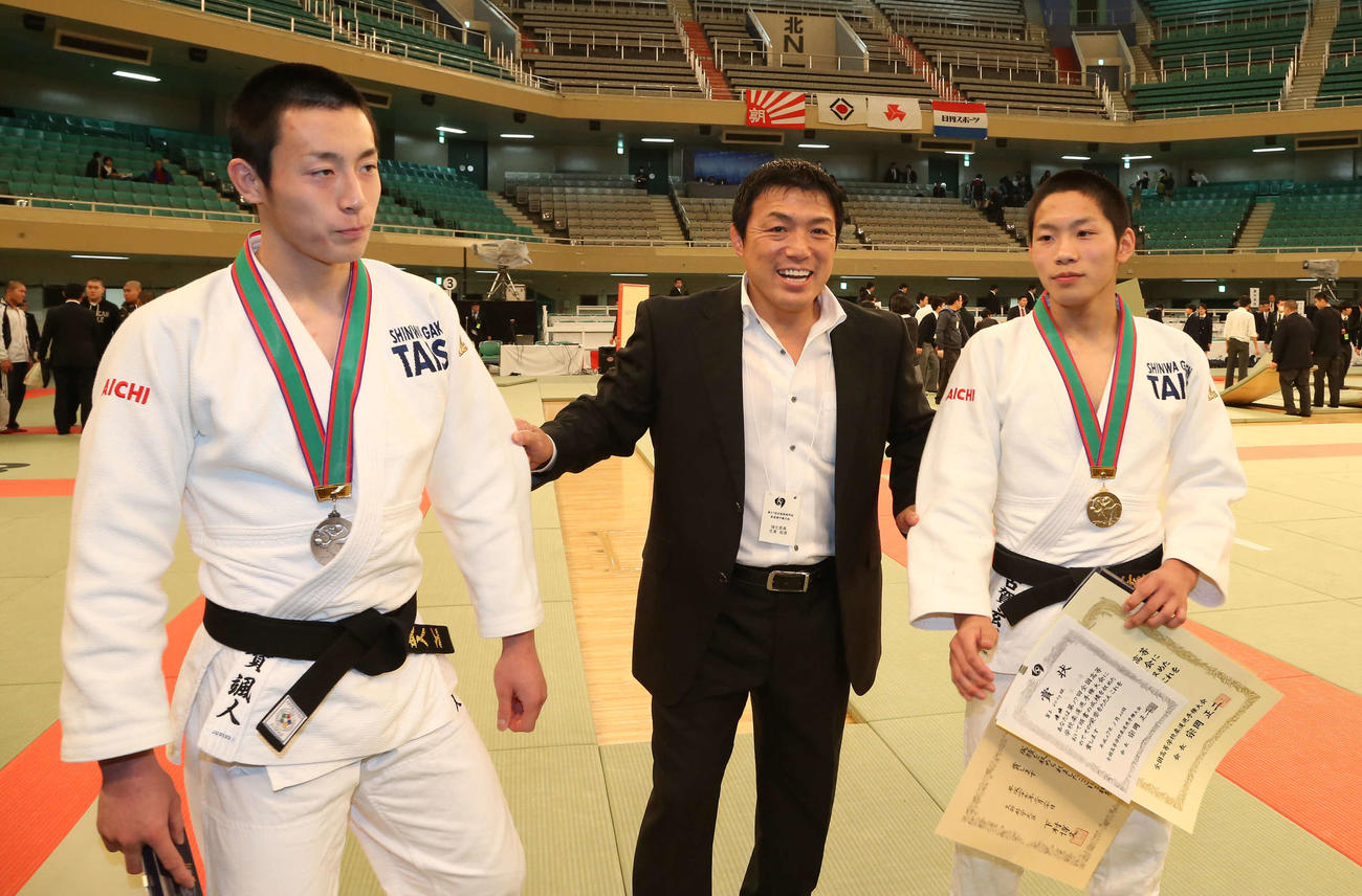 15年3月20日、全国高校柔道選手権で兄弟そろっての優勝はならなかったが、2人の息子の活躍に笑顔をみせる古賀稔彦さん（中央）。左は73キロ級で準優勝の颯人。右は60キロ級で優勝した玄暉