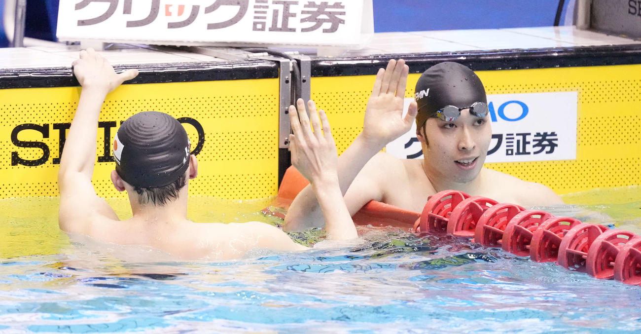 男子200メートル背泳ぎで2位の萩野（右）は優勝の入江とタッチを交わす（撮影・鈴木みどり）