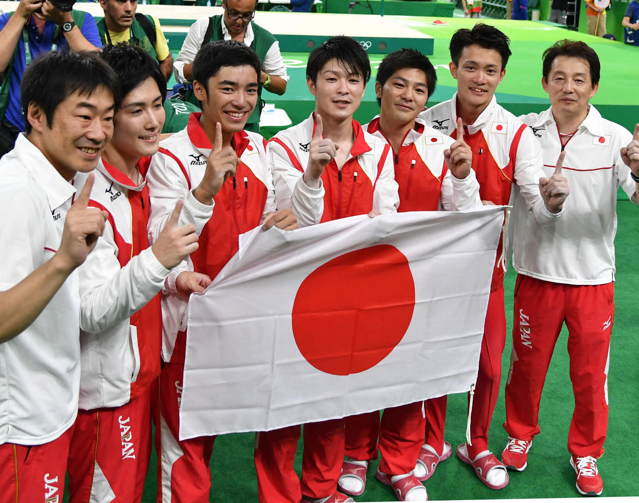 体操・男子団体総合決勝　金メダルを獲得した日本チーム。左から森泉貴博コーチ、加藤凌平、白井健三、内村航平、山室光史、田中佑典、加藤裕之コーチ（2016年8月8日撮影）