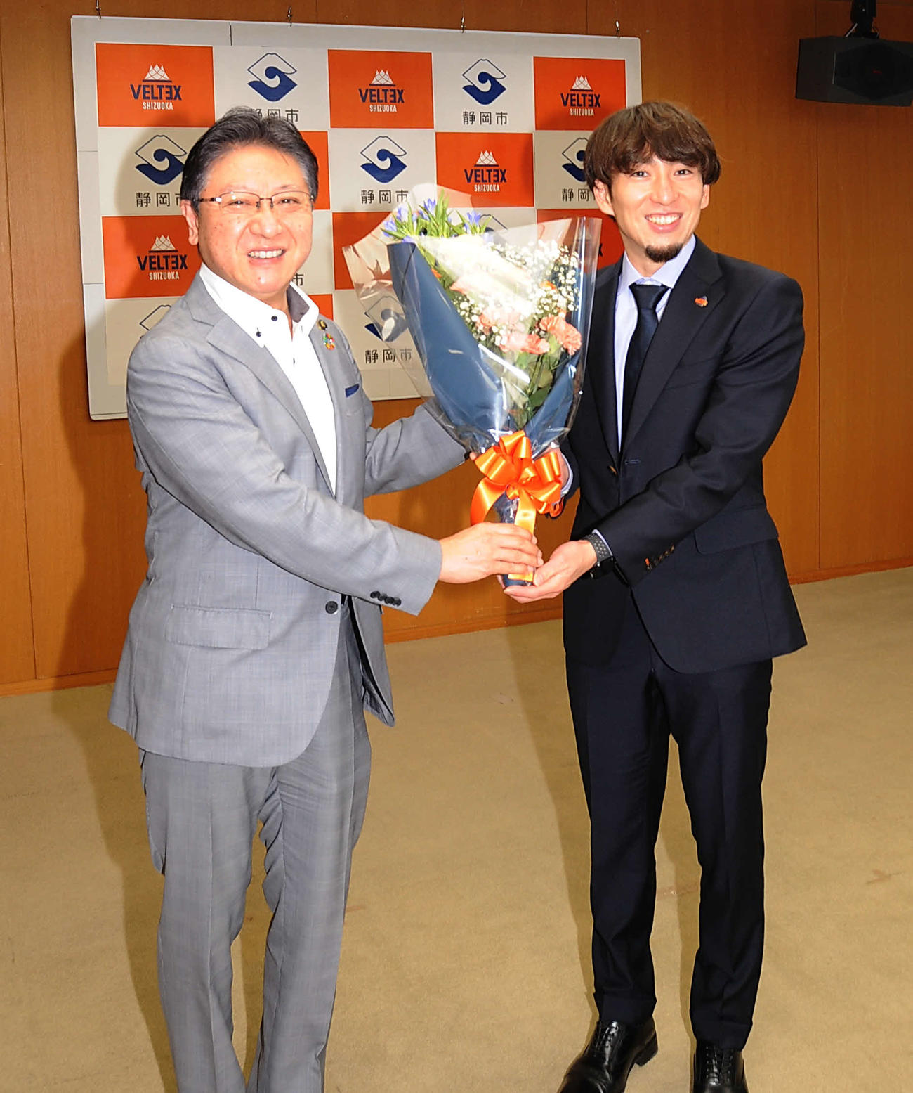 田辺静岡市長（左）から花束を受け取り笑顔を見せるベルテックス静岡の大石