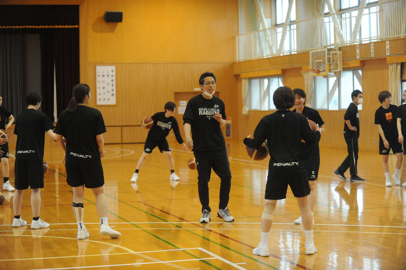 練習中、選手に気さくに声をかける伊藤監督（中央）
