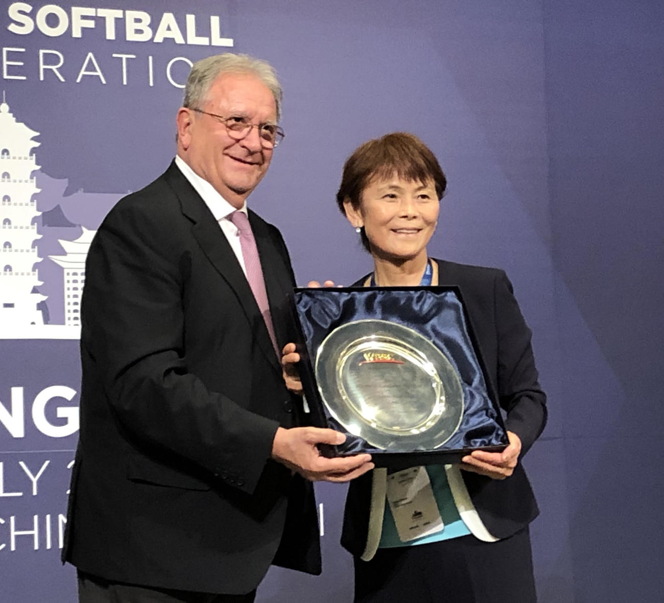 2021年のソフトボール年間最優秀選手賞に輝いた藤田倭への記念皿を代理で受け取る日本協会の宇津木妙子副会長（同協会提供）