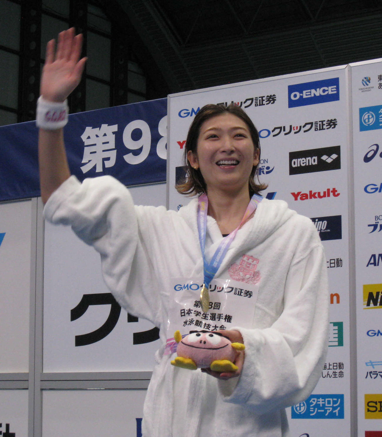 女子50メートル自由形を2連覇し、表彰台から手を振る池江（撮影・吉池彰）
