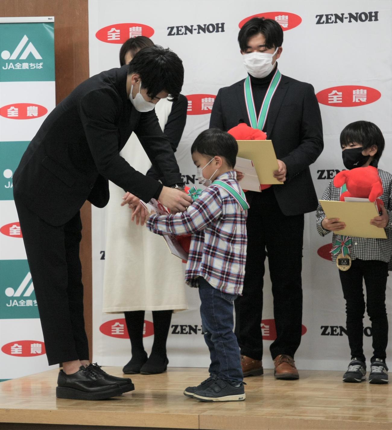 「ユメトコメキャンペーン」千葉米贈呈式に出席し、金賞を受賞した武田睦希さん（手前右）にメダルを授与する公式アンバサダーの橋本（手前左）（撮影・藤塚大輔）