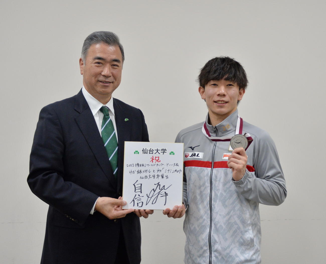 銀メダルを手に記念撮影する南（右）と高橋仁学長