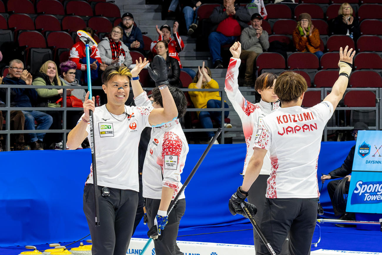 世界選手権1次リーグで笑顔を浮かべるカーリング男子日本代表のメンバー（C）WCF／Steve Seixeiro