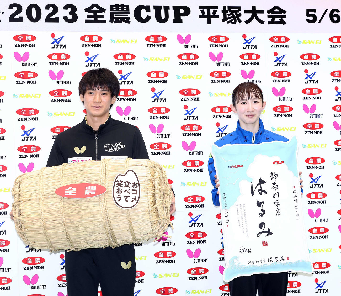 米俵を手に写真に納まる戸上（左）と早田（撮影・河田真司）