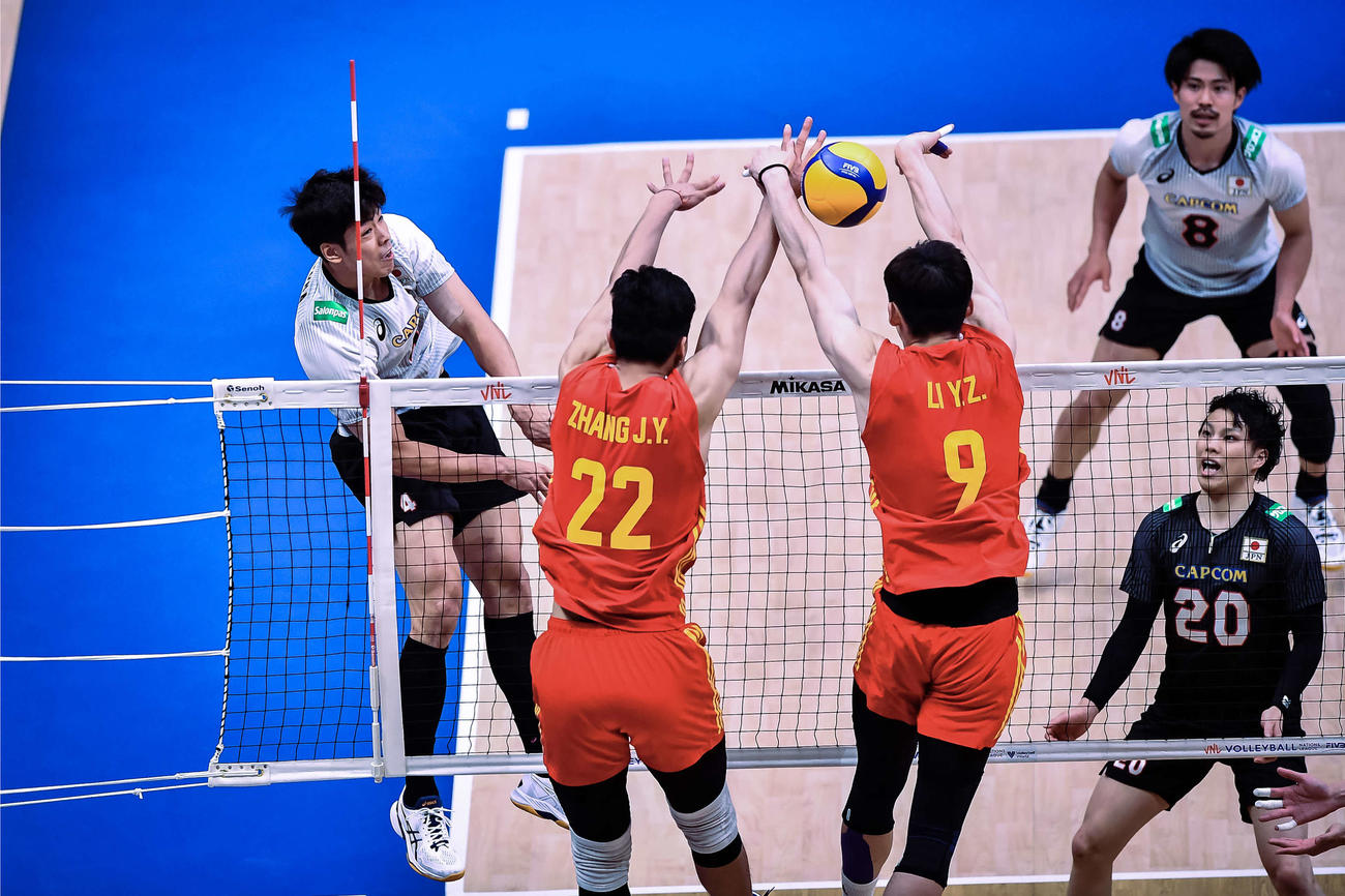 スパイクを放つ宮浦（左）（C）FIVB