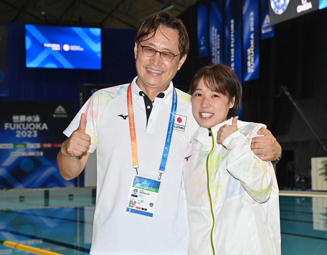 女子高飛び込み準決勝7位で決勝に進出し、パリ五輪代表が内定した荒井（右）は、馬淵コーチと笑顔でポーズを決める（撮影・岩下翔太）