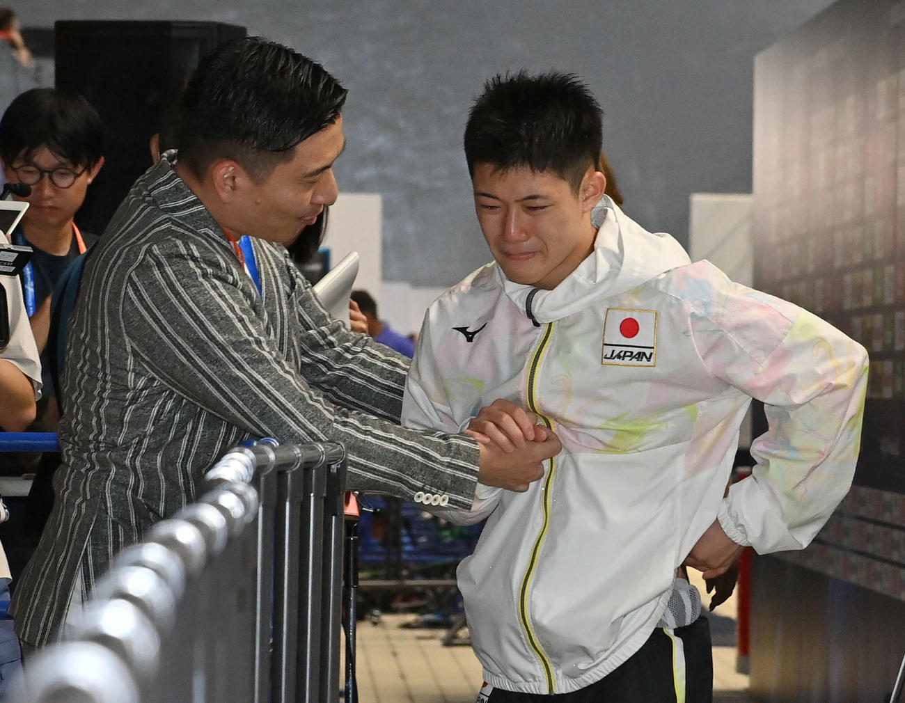 世界水泳2023福岡大会第8日　男子高飛び込み準決勝7位で決勝に進出し、パリ五輪代表が内定した玉井陸斗（右）は、涙しながら寺内健と握手を交わす（撮影・岩下翔太）