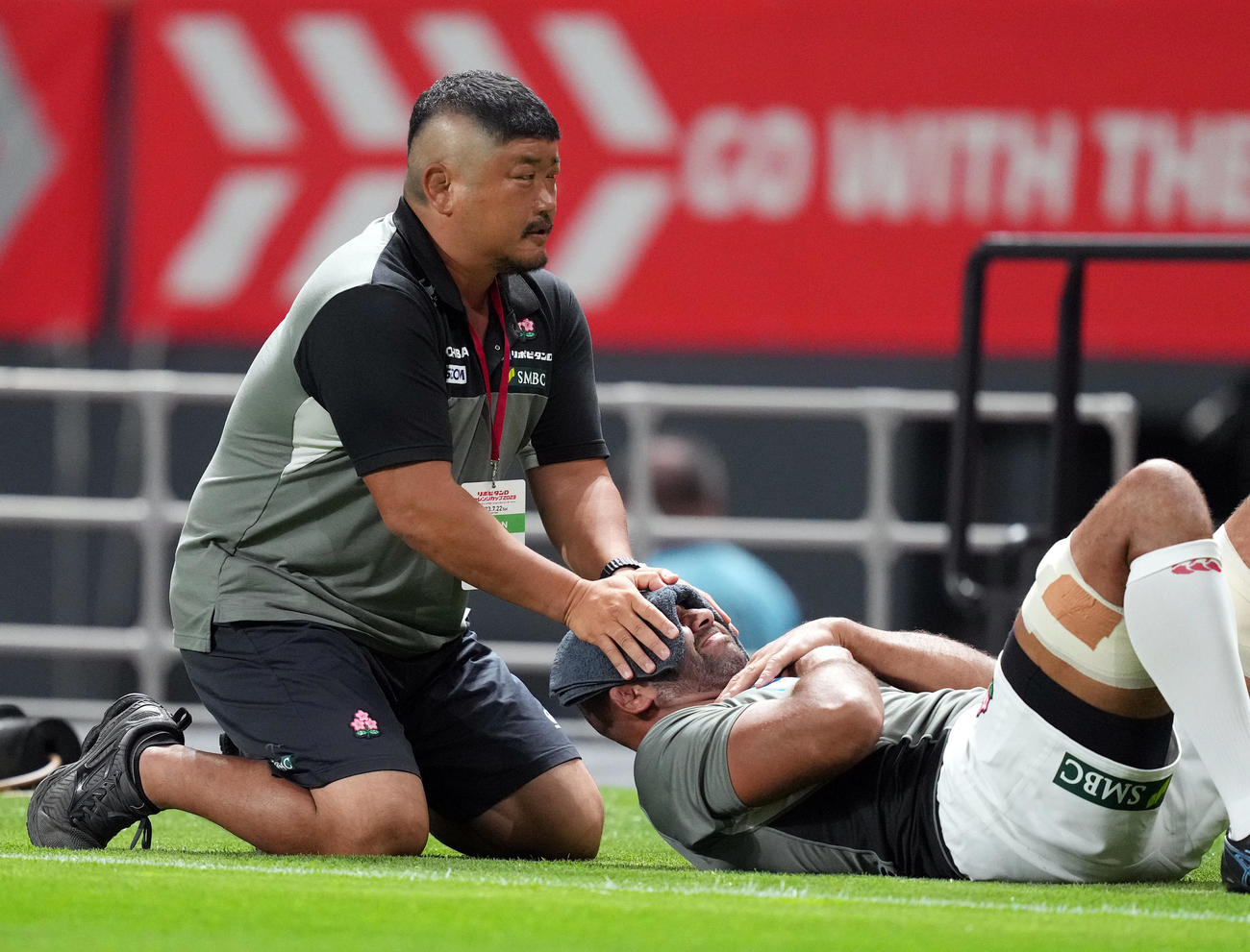 日本対サモア　試合前、長谷川コーチ（左）に首をストレッチしてもらうNO8リーチ（撮影・狩俣裕三）