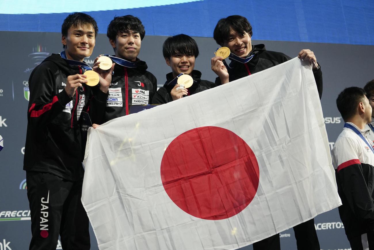 金メダルを掲げる日本代表。左から主将の松山恭助、敷根崇裕、飯村一輝、鈴村健太（AP）