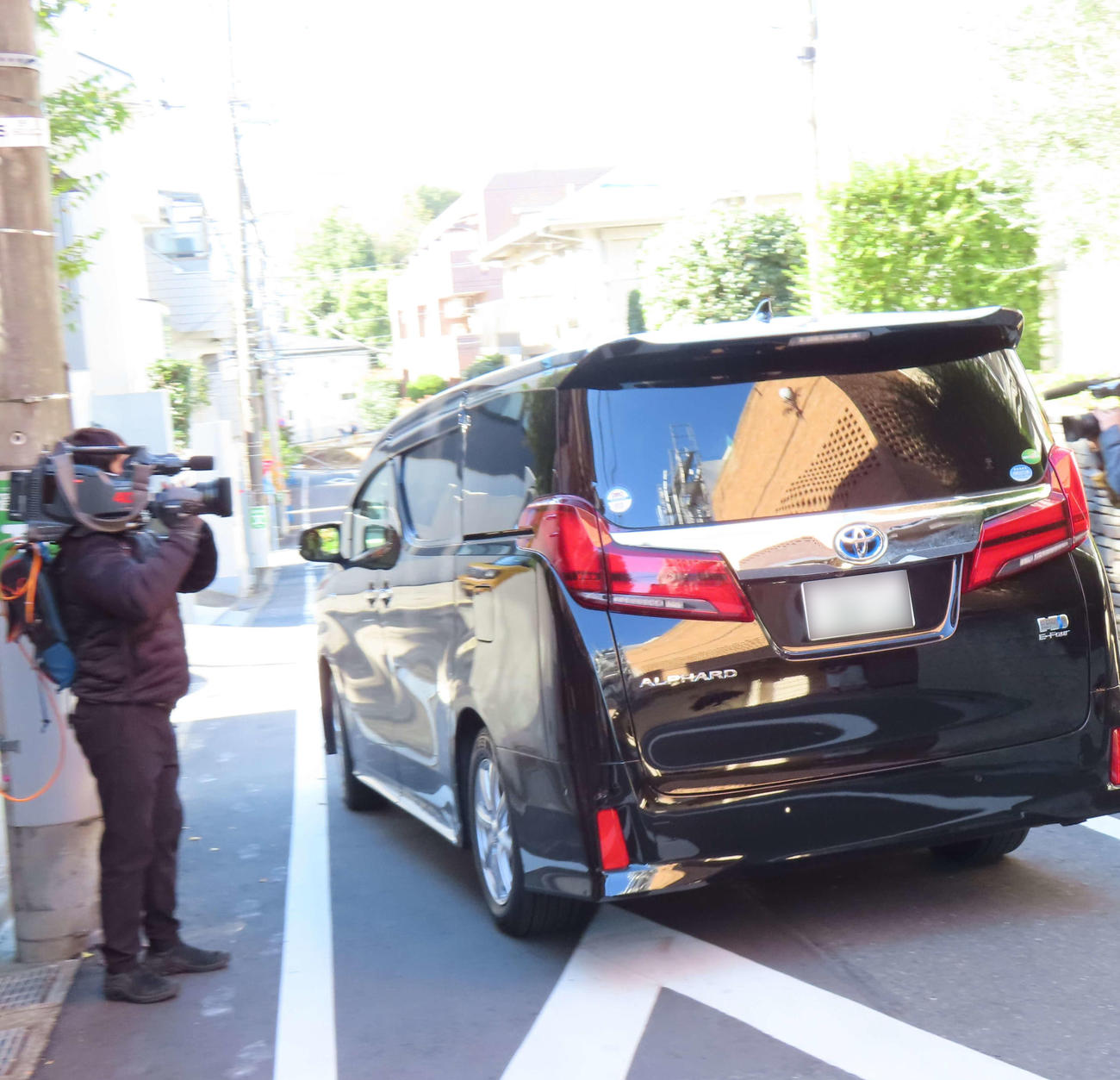 自宅を後にする林理事長を乗せた車（一部加工）