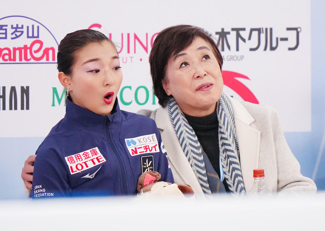 女子SPの演技後、キス・アンド・クライで得点を確認し驚く坂本（左）。右は中野コーチ
