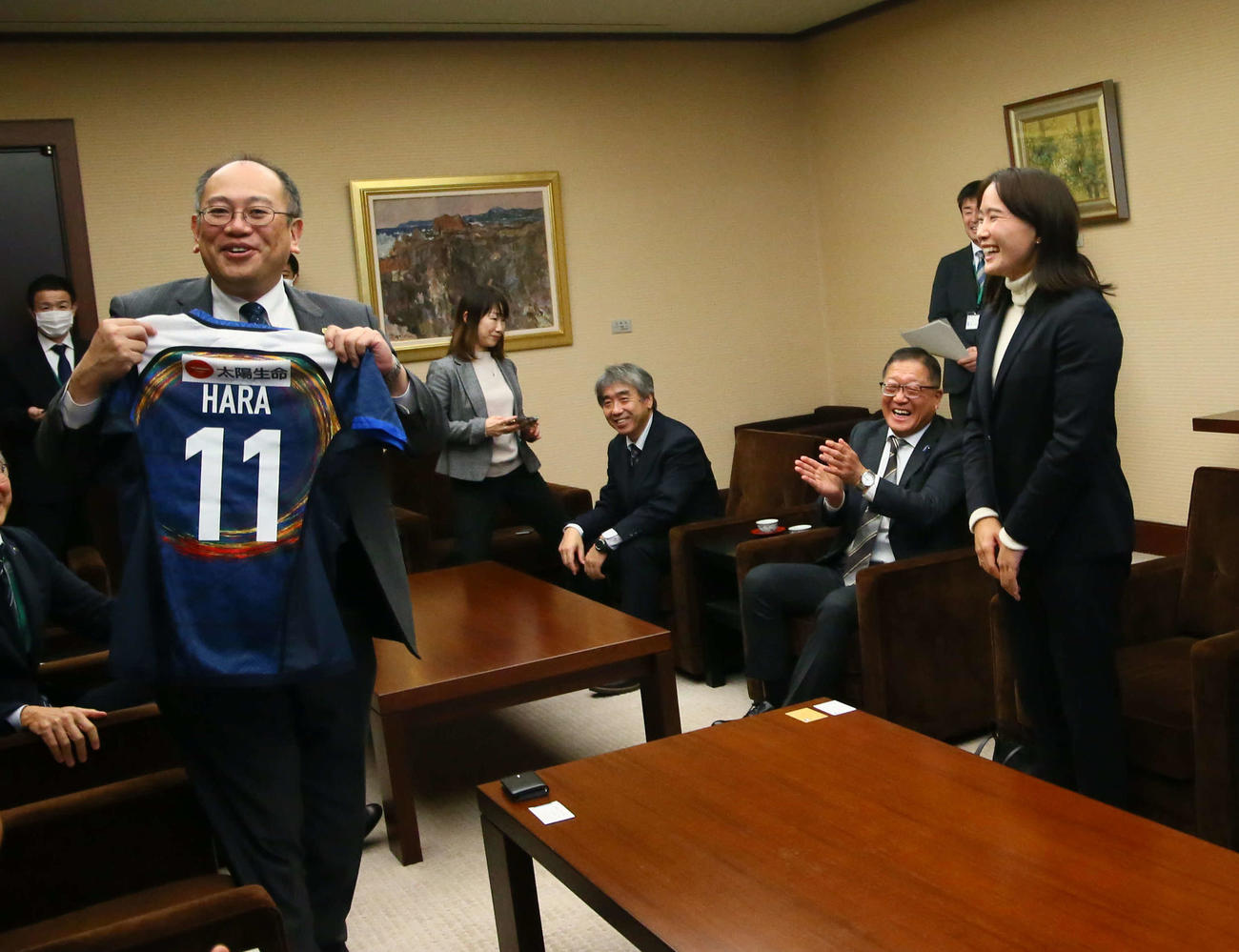 橋本副知事（左）は原（右）からジャージーを贈られうれしそうに笑う