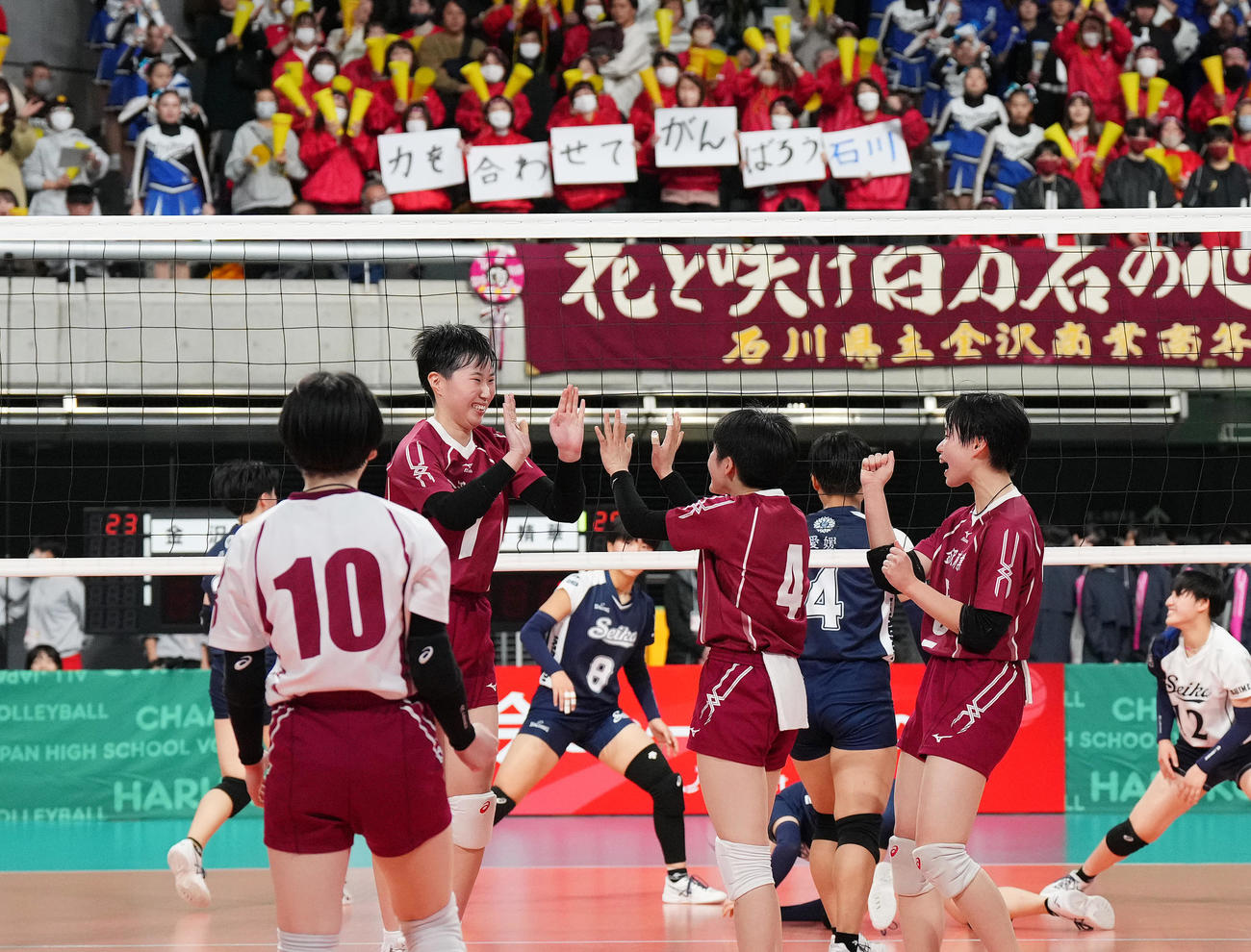 金沢商対今治精華　第2セット、「力を合わせてがんばろう石川」と掲げられたメッセージを前にポイントを奪い喜ぶ金沢商の選手たち（撮影・菅敏）
