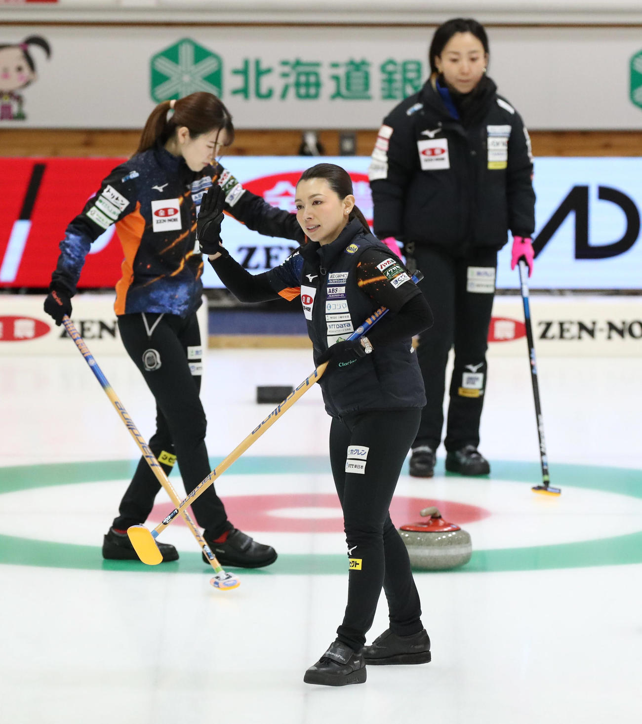 ロコ・ソラーレS対ロコ・ソラーレ　第1エンド、味方のショットに手を振って応えるロコ・ソラーレSの本橋（中央）（撮影・佐藤翔太）