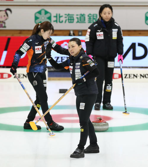 ロコ・ソラーレS対ロコ・ソラーレ　第1エンド、味方のショットに手を振って応えるロコ・ソラーレSの本橋（中央）（撮影・佐藤翔太）