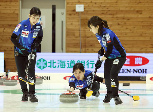 ロコ・ソラーレ対グランディール　第3エンド、ショットを放つロコ・ソラーレの吉田知。左は吉田夕、右は鈴木（撮影・佐藤翔太）
