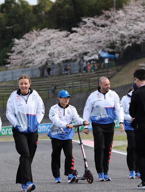 F1日本GPが開幕し、S字コーナーに咲く桜をバックにコースチェックをするRBの角田裕毅（撮影・宮崎幸一）