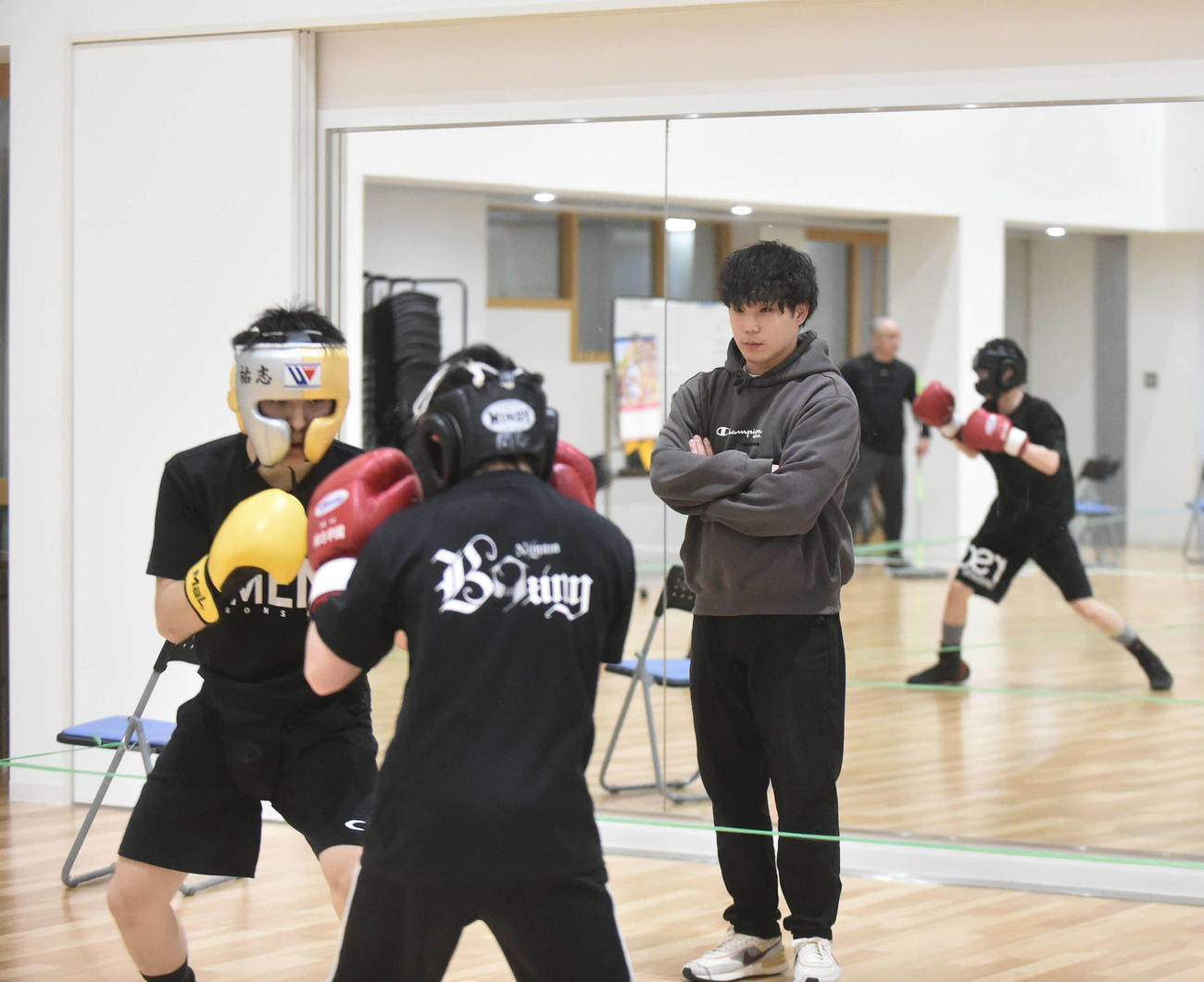 マスボクシングをする選手を見守る小林助監督