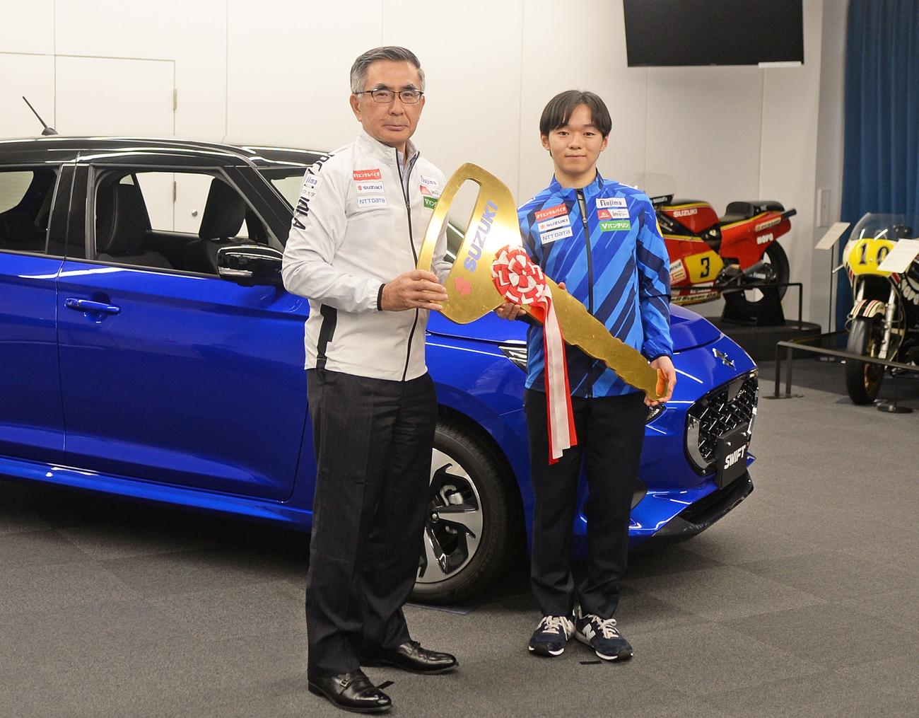 提供される車の前で記念撮影する鍵山（右）とスズキの鈴木社長