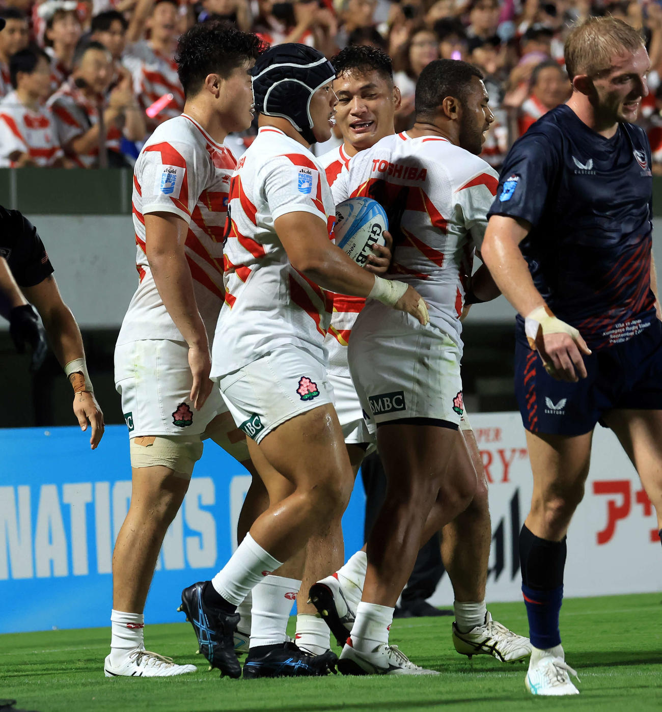 日本対米国　前半、トライを決めフィフティーンに祝福される原田（中央）（撮影・浅見桂子）
