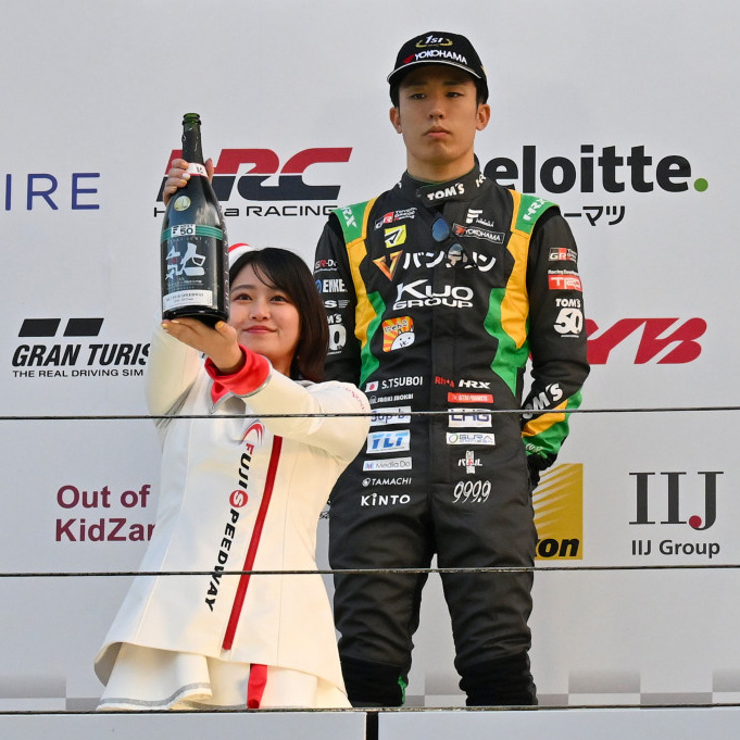 スーパーフォーミュラ第7戦で優勝した坪井翔にスパークリング大吟醸を届けるスタッフ（JRP提供）