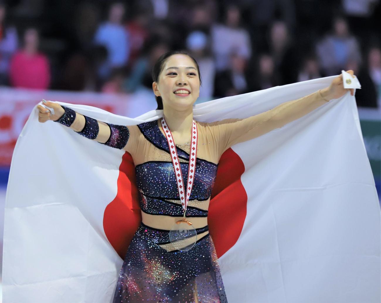 フィギュアスケートGPシリーズスケートカナダ　表彰式で日の丸を掲げる吉田陽菜（撮影・藤塚大輔）