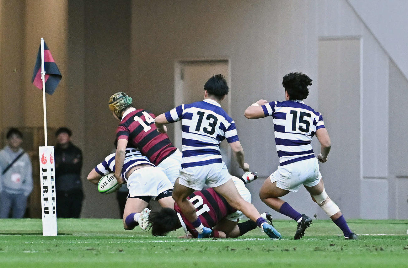 早大対明大　後半、早大・田中（左から2人目）は明大・伊藤にタックルしトライを阻止する（撮影・滝沢徹郎）