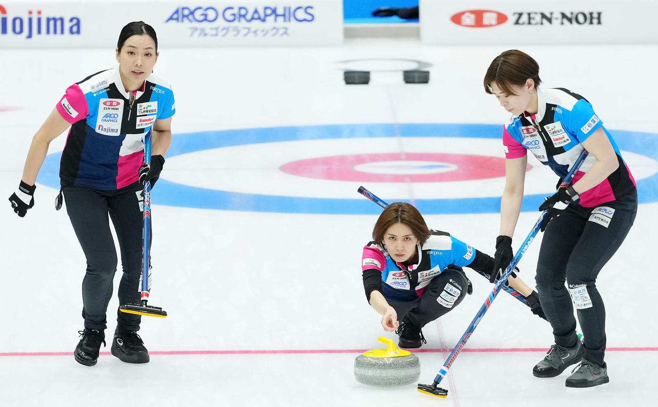 札幌国際大対フォルティウス　第4エンド、ストーンを投じるフォルティウス吉村。左は近江谷、右は小野寺（撮影・横山健太）