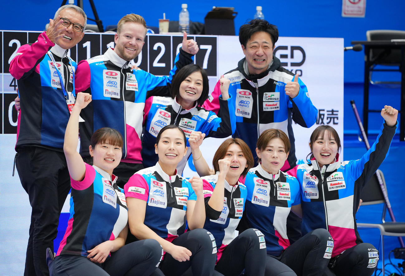 フォルティウス対北海道銀行　優勝し笑顔で写真に納まるフォルティウスの選手たち。前列左から小谷、近江谷、吉村、小野寺、小林、後列左から白井メンタルコーチ、エディン・コーチ、船山コーチ、松井トレーナー（撮影・垰建太）