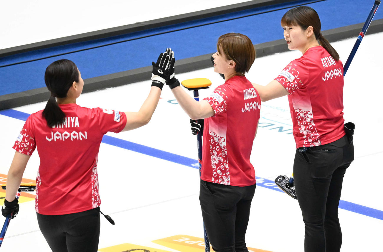 第4E、ハイタッチする右から小谷、小野寺、近江谷（撮影・飯岡大暉）