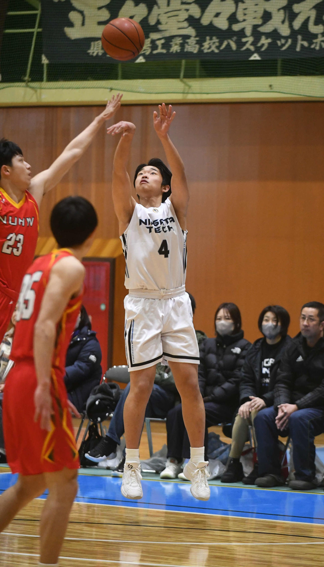 新潟医療福祉大戦で3点シュートを放つ新潟工の佐藤主将（右）