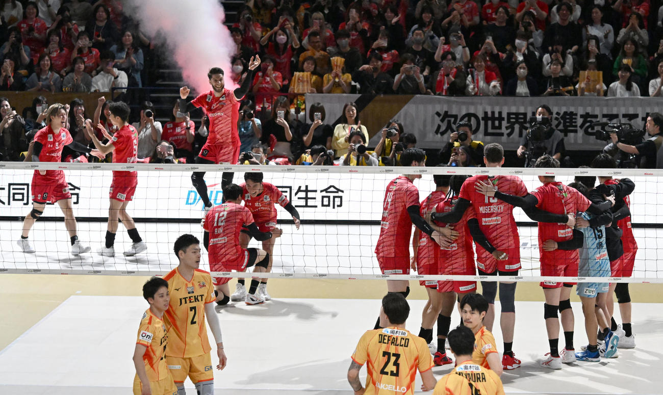 SVリーグ　サントリー対愛知　ストレート勝ちで優勝を決め、喜ぶサントリーの選手たち。手前は肩を落とす愛知の選手（撮影・千葉一成）