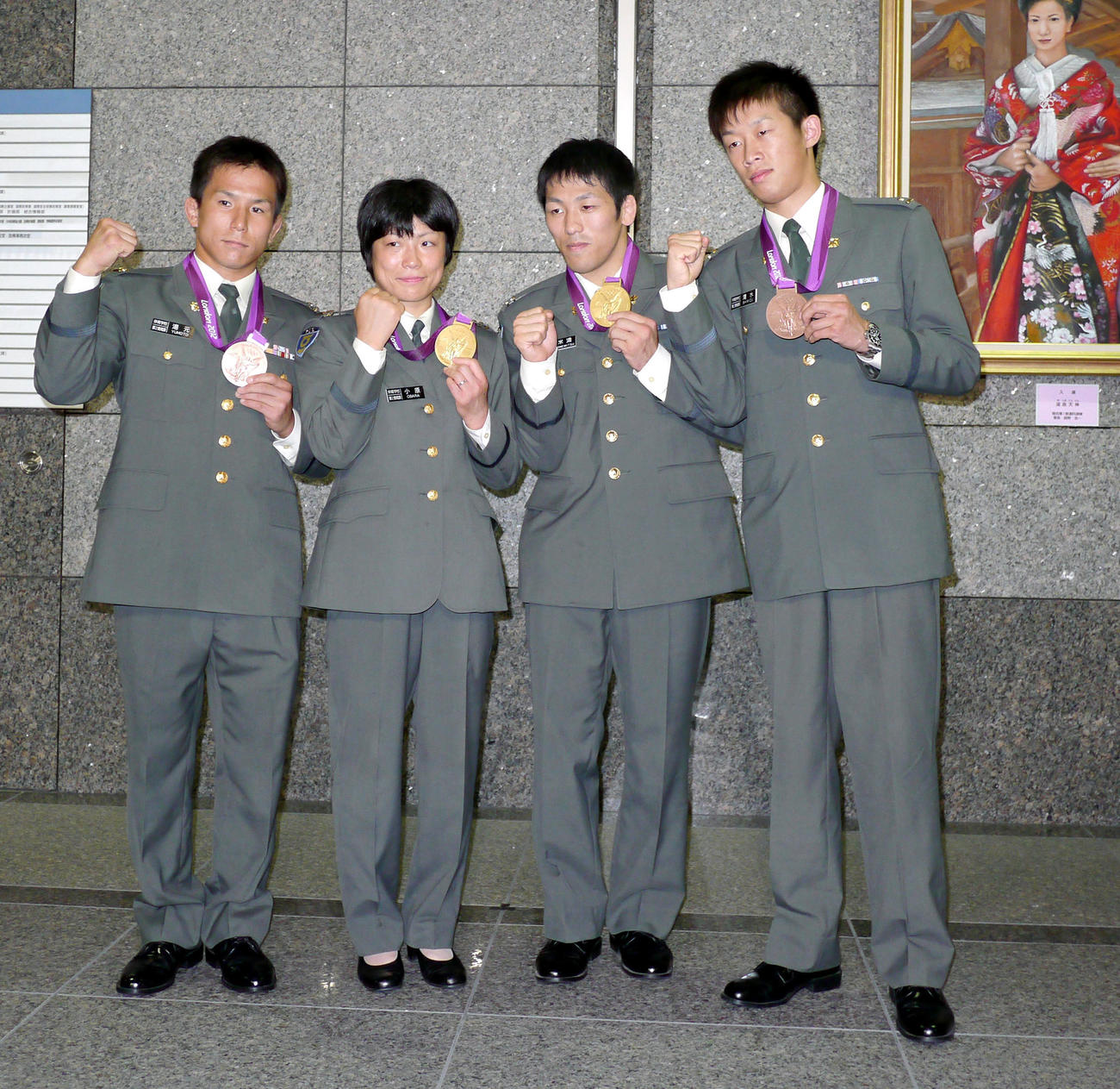 防衛省で行われた帰国報告会でメダルを提げる左からレスリング男子フリー55キロ級銅メダルの湯元進、女子48キロ級金メダルの小原さん、男子フリー66キロ級の金メダル米満、ボクシング・バンタム級銅メダルの清水