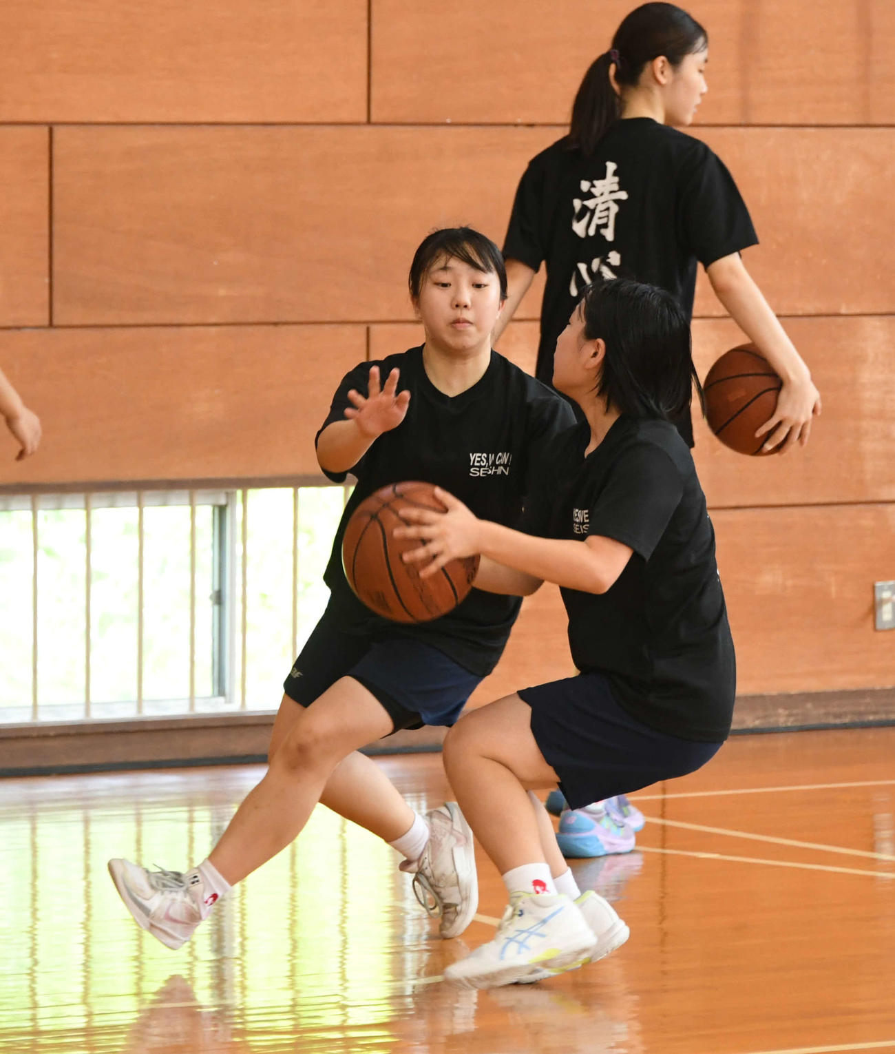 練習で粘り強く守備をする小池主将（左）