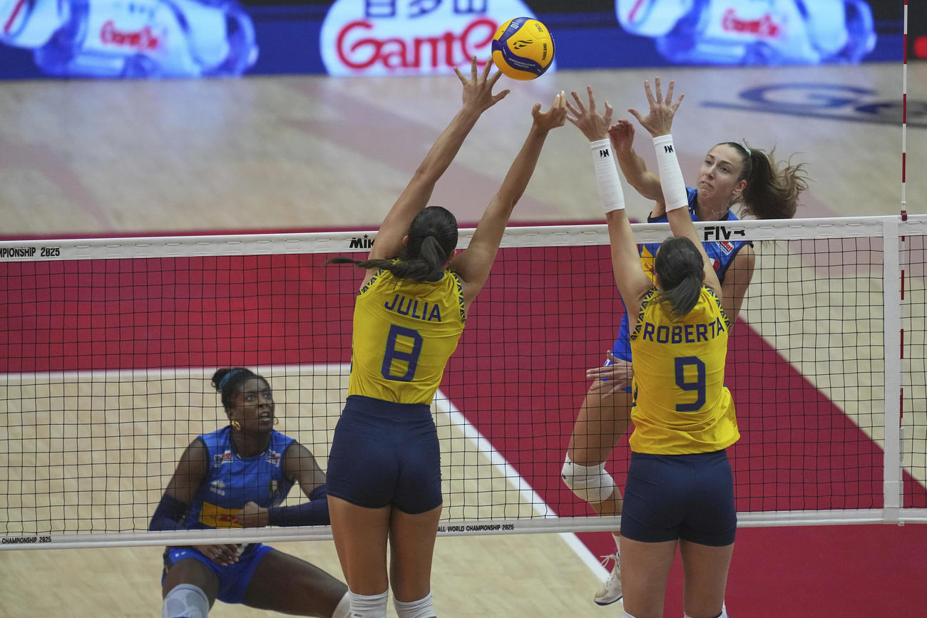 イタリア対ブラジル戦　イタリアのステラ・ネルヴィーニ（右）がブラジルのロベルタ・シルバ・ラツケ（右）とジュリア・ガンバット・クディエスを相手にスパイクを打つ（AP）