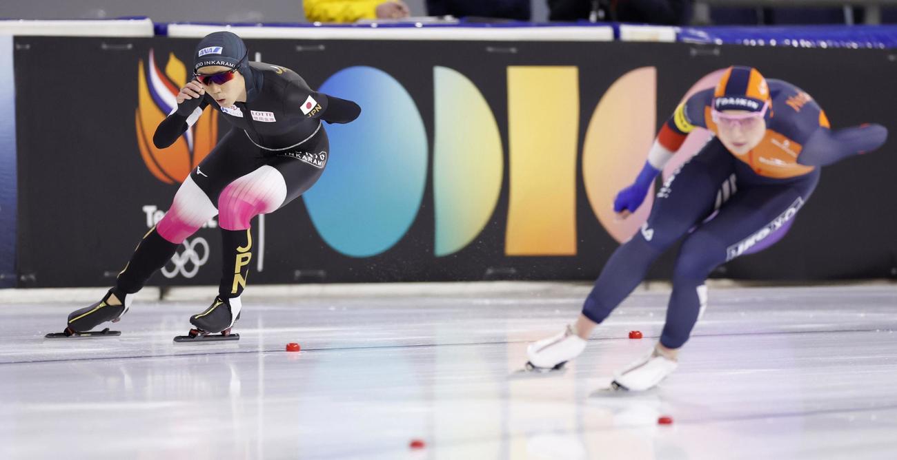 女子1500 メートル で滑走する高木美帆（左）。右手前は優勝したヨイ・ベーネ（共同）