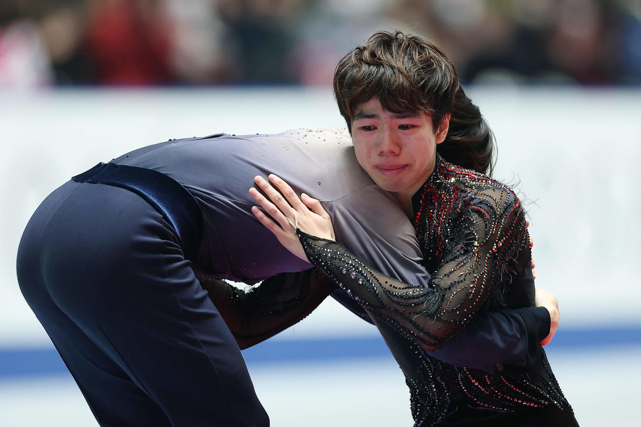 表彰式で優勝の鍵山と抱き合う2位の佐藤（撮影・前田充）