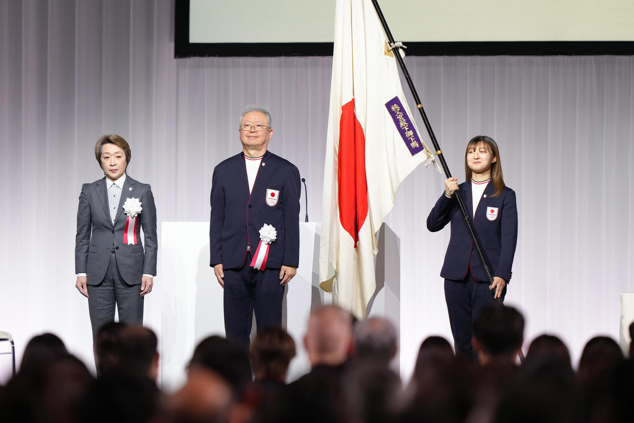 結団式で団旗を受け取った旗手代行の坂本（右）。左からJOC橋本会長、日本選手団伊東団長（撮影・足立雅史）