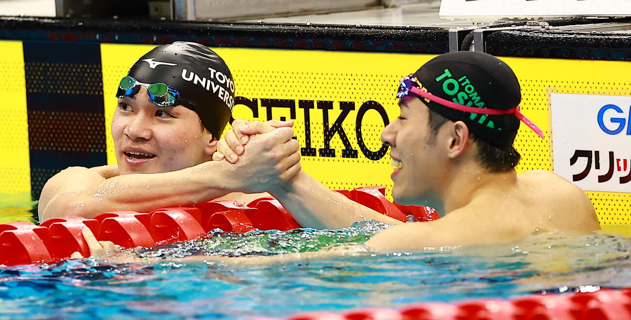 男子200メートルバタフライで優勝し、2位の本多（右）と喜ぶ喜ぶ松下（撮影・野上伸悟）