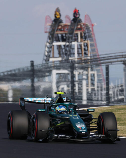 ジェットコースターをバックに快走するアストンマーティンホンダのアロンソ（撮影・宮崎幸一）