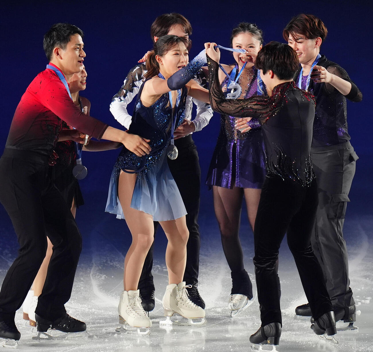 五輪の演目を披露した佐藤駿（手前右）にメダルをかける坂本花織（中央）（撮影・清水貴仁）
