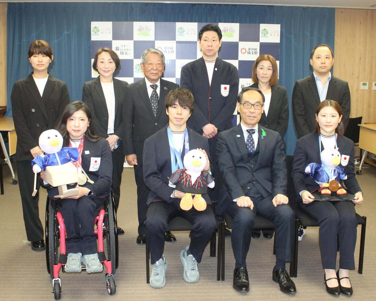 成果報告会で写真に納まる（下段左から）村岡桃佳、佐藤駿、大野元裕埼玉県知事、小野光希
