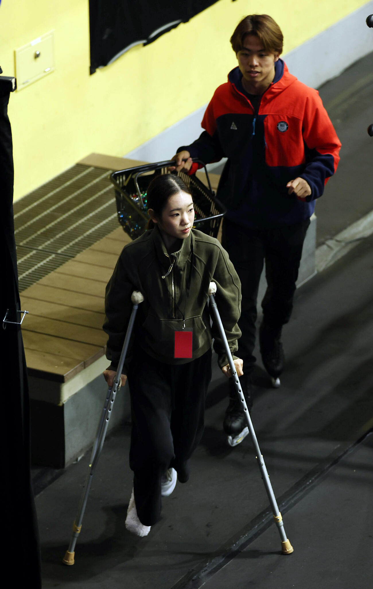 松葉づえで移動する長岡柚奈。後方は森口澄士（撮影・前田充）