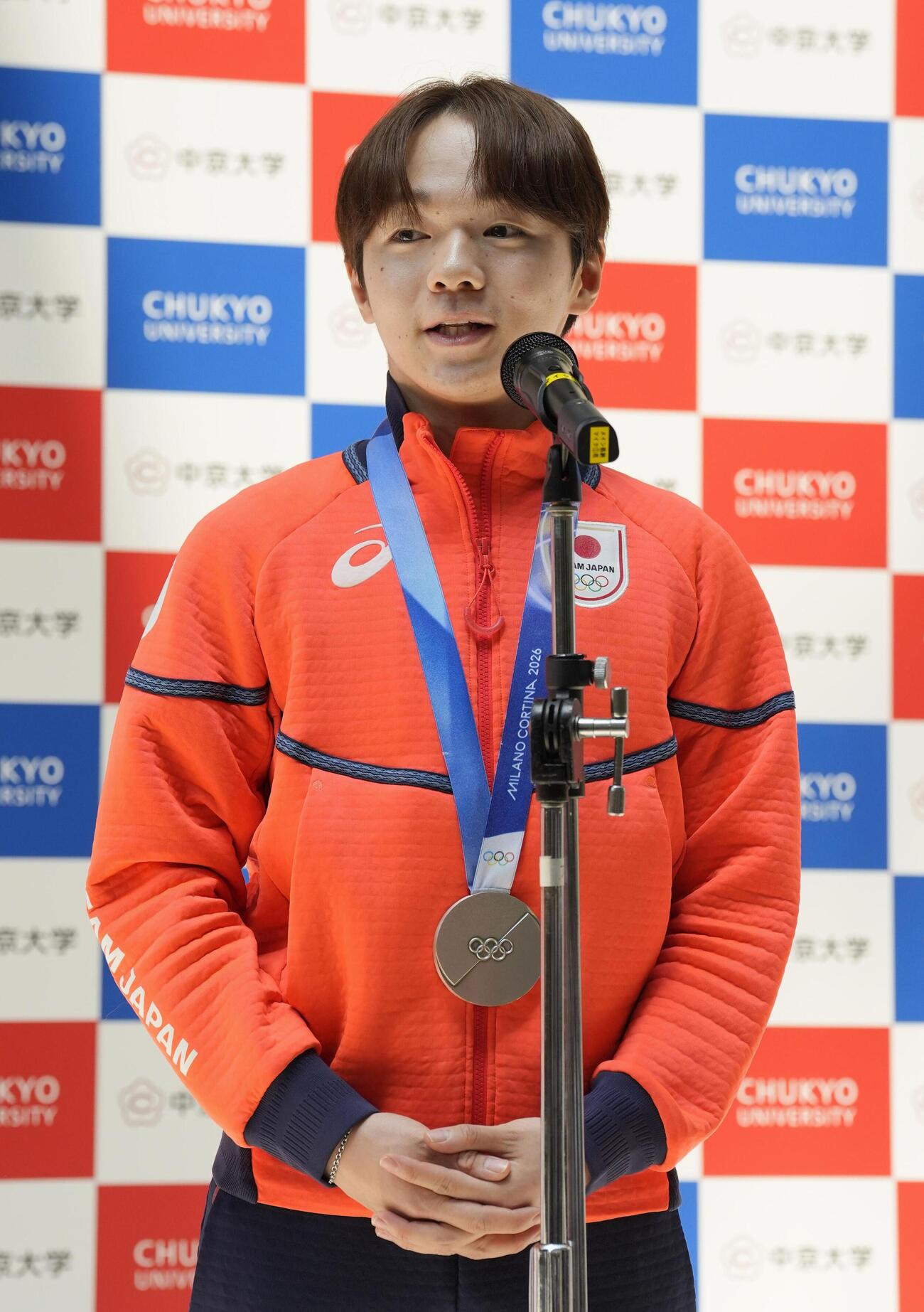 中京大で開かれたミラノ五輪報告会であいさつする鍵山優真＝15日、名古屋市（共同）