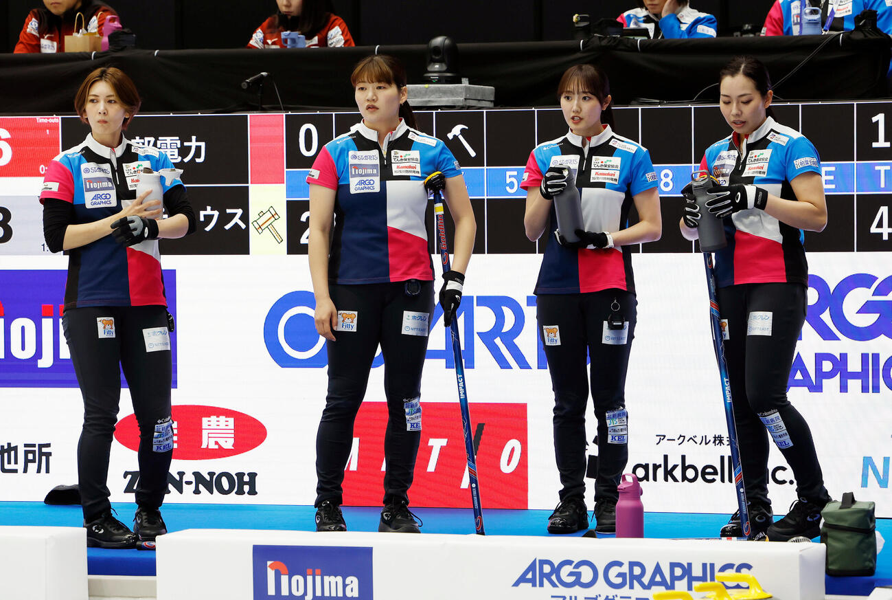 日本カーリング選手権大会　横浜2026　女子プレーオフ　中部電力対フォルティウス　第4エンド、水分補給をしながら話し合うフォルティウスの選手たち、左から吉村紗也香、小谷優奈、小林未奈、近江谷杏菜（撮影・山本朝陽）