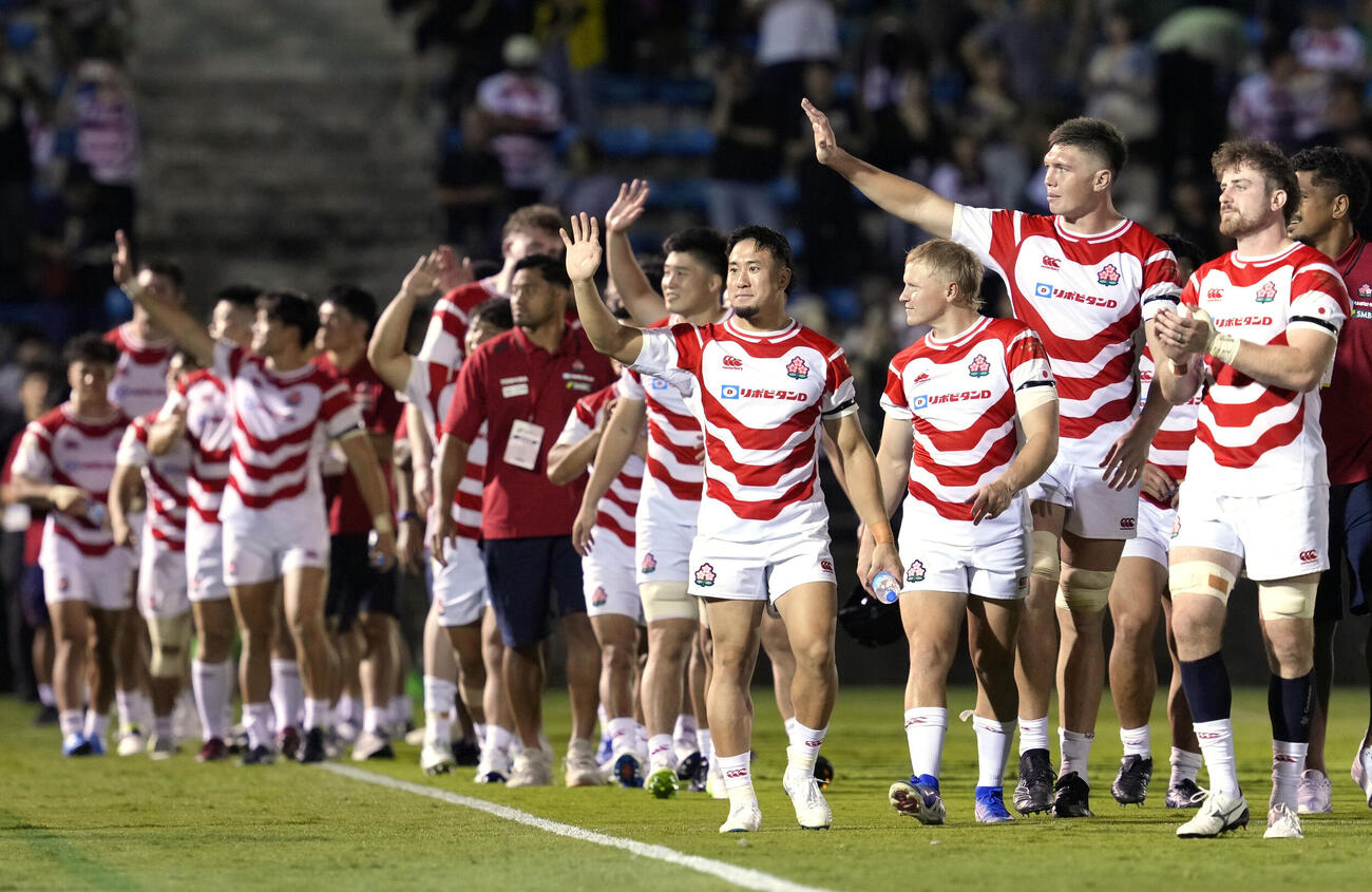 イタリアに勝利し、スタンドの声援に応える松永（右から4人目）ら＝秩父宮（共同）
